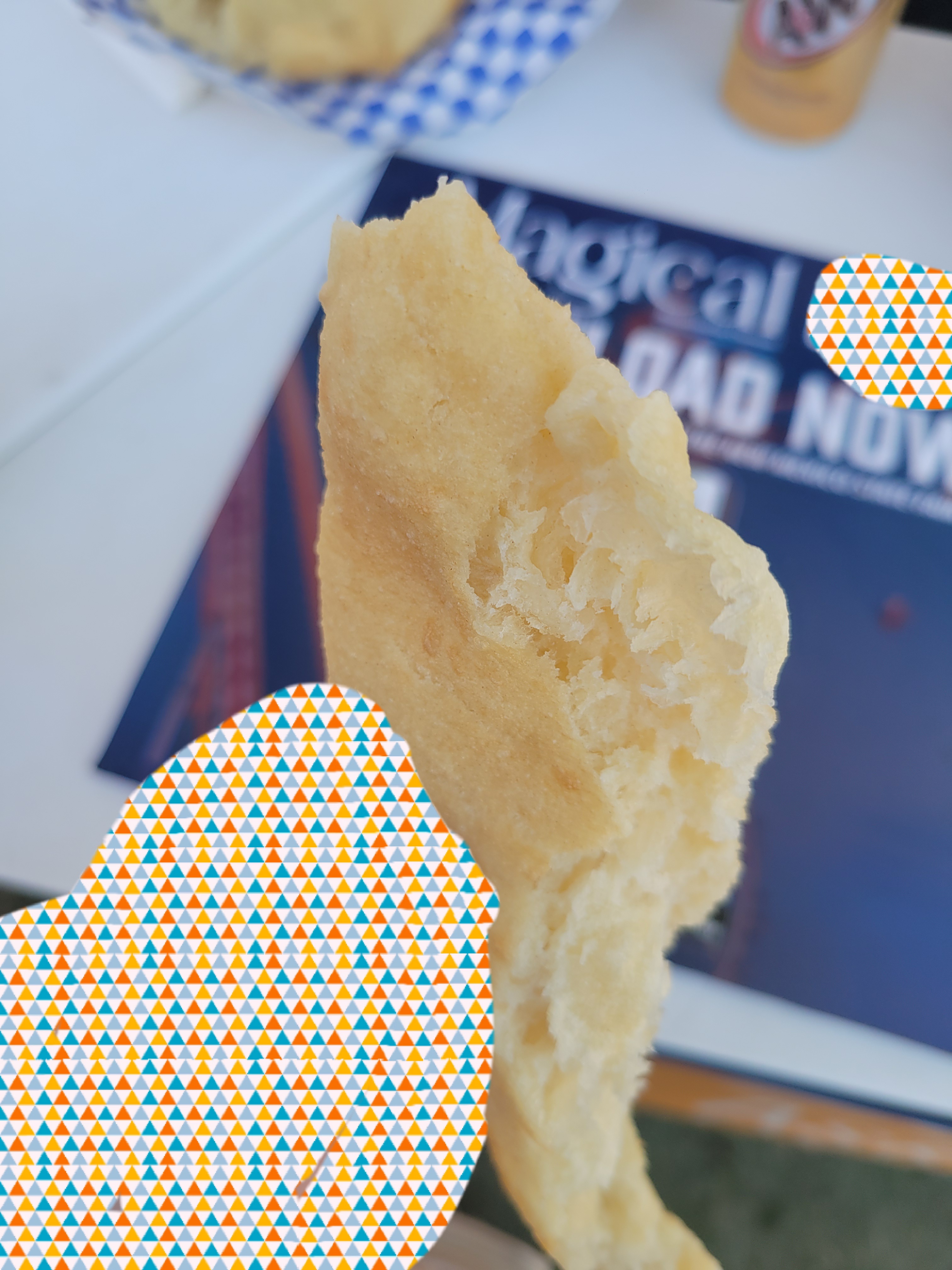 Hand holds piece of fried bread.